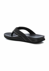 Chancla negra con suela texturizada, tiras de goma y acentos de costura blanca. Diseño ligero, adecuado para uso casual.