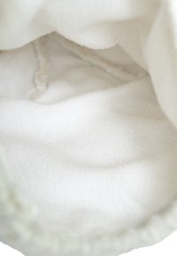 Fleece-lined pouch with a soft white interior, featuring smooth texture and rounded shape; outer edges lightly gathered for a snug fit.