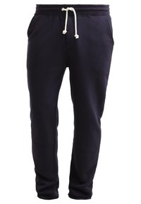 Marinblå sweatpants i mjukt material, med elastiskt midjeband med snörning och två sidofickor. Rakt ben-design.