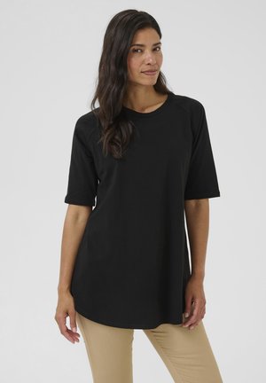 Black, short-sleeve top with a round neckline and loose fit, made of soft fabric. Features raglan sleeves and a curved hemline.