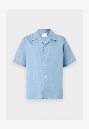 Camisa azul claro de manga corta con botones, cuello clásico y botones blancos, extendida sobre un fondo neutro.