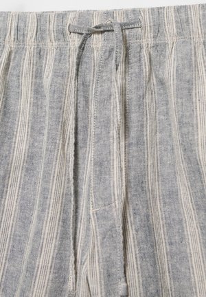 Pantalon léger en tissu avec des rayures verticales crème et grises et un cordon noué à la taille élastique.