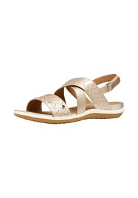 Beige open-toe sandal with perforated straps, adjustable back strap, white midsole, and textured brown rubber outsole.