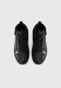 Black high-top sneakers made of textured leather, featuring laces, a side zipper, and a smooth rubber sole.