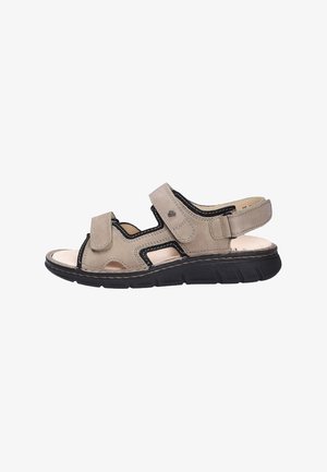 Beige open-toe men's sandal with black sole, two adjustable velcro straps on top, and one adjustable strap at the heel.