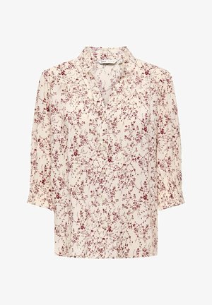 Kremfarvet bluse med mørkerødt blomsterprint, knapper foran, trekvartlange ærmer og rynkede manchetter.
