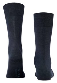 Calze nere al ginocchio realizzate in un tessuto morbido ed elastico. Texture a coste sulla parte superiore e corpo a maglia piatta. Presenta un dettaglio con il logo vicino al tallone.