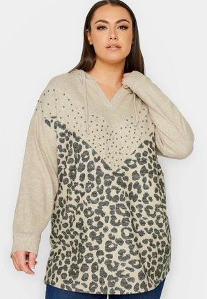 Beige hoodie met een v-hals, met een gestructureerde bovenkant verfraaid met rhinestones en een panterprintpatroon op de onderste helft.