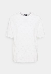 Bílé tričko s krátkými rukávy s jednoduchým celoplošným vzorem malých log Nike a kruhů. Vyrobeno z hladké látky, má kulatý výstřih.