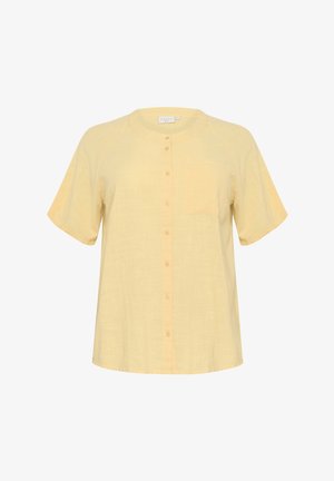 Heled kollane lühikeste varrukatega särk, valmistatud linast, ümmarguse kaelusega, nupuga ette ja vasakul rinnal väikese taskuga. Sile ja hingav tekstuur.