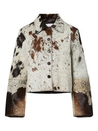 Veste en peau de vache avec col, présentant un mélange de taches blanches, brunes et noires. Comprend de grands boutons et des manches larges.