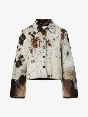 Cowhide jacket with a collar, featuring a blend of white, brown, and black patches. Includes large buttons and wide sleeves.