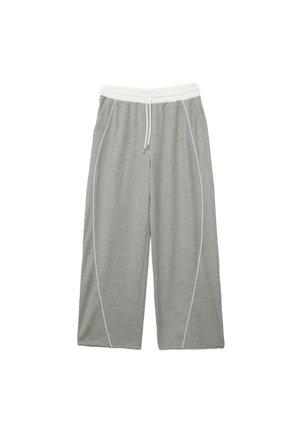 Pantaloni della tuta grigi a gamba larga con vita elastica bianca, coulisse bianca e cuciture laterali curve bianche, distesi su uno sfondo bianco.