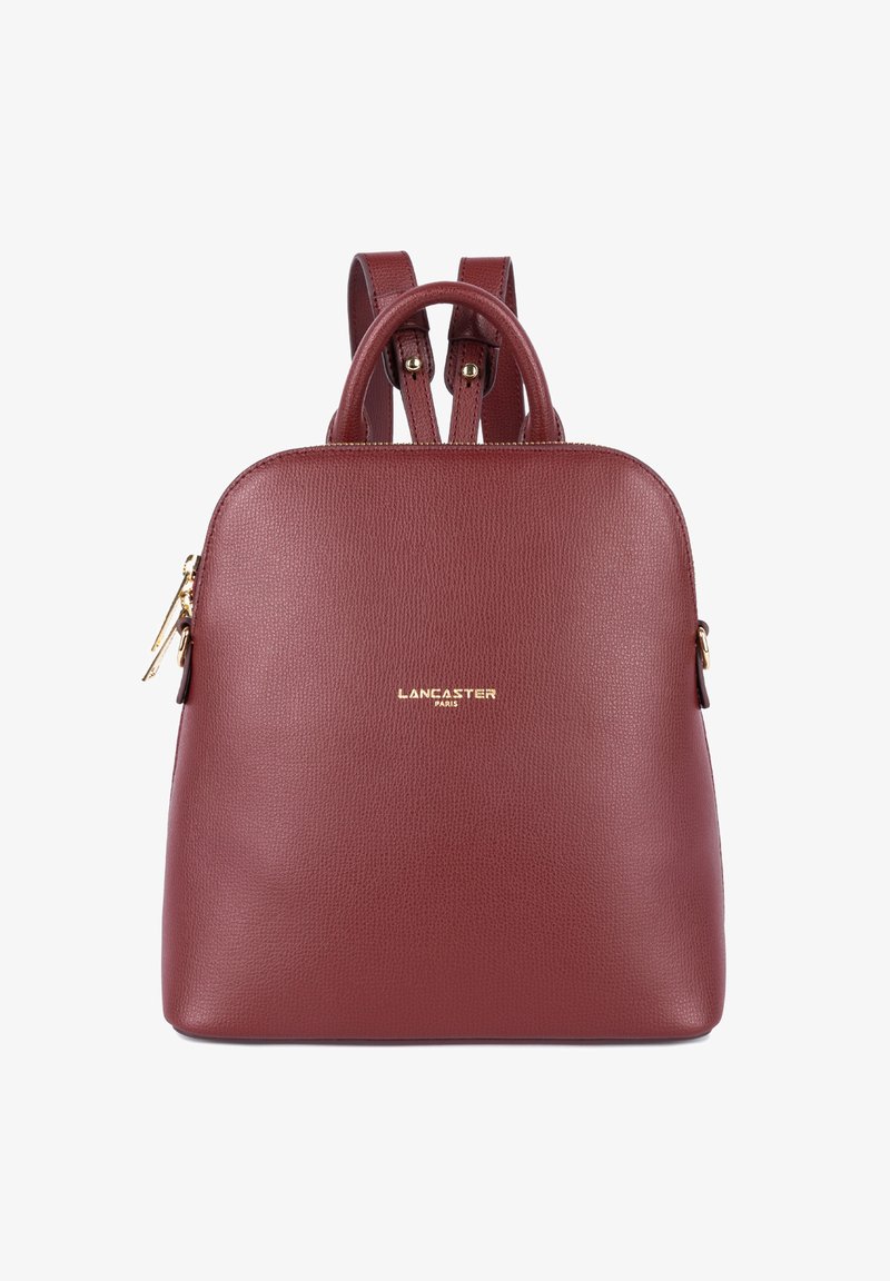 Zaino in pelle bordeaux con texture liscia, dettagli in metallo dorato, doppie maniglie superiori e spallacci regolabili. Presenta un logo.