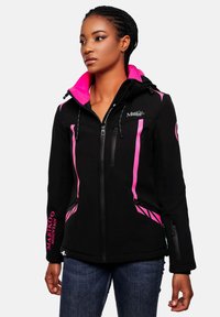 Woman wearing a black softshell jacket with pink accents, zippered pockets, and "Marikoo Mountain" logo, paired with dark blue jeans.