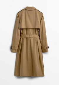Khaki trench coat with a belted waist, double-breasted design, and buttoned cuff details. Features a back yoke and a classic collar.