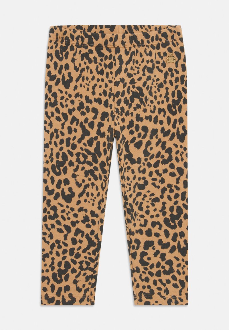 Tevebőr mintás leggings, bézs színben fekete foltokkal, puha, rugalmas anyaggal és kényelmes, elasztikus derékkal a tökéletes illeszkedés érdekében.