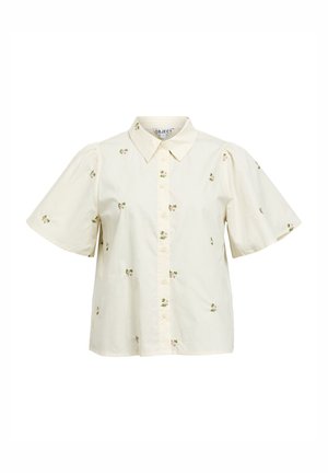Blouse crème à manches courtes avec de petites imprimés floraux roses, boutonnée à l'avant et col pointu.