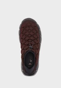 Burgundy sneaker with a textured woven upper, black interior, and rubber sole. It features an adjustable lacing system for a secure fit.