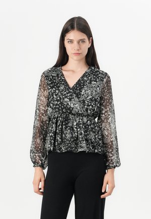 Black floral wrap blouse with long, sheer sleeves, a V-neckline, and a peplum hem. Features delicate white floral patterns throughout.