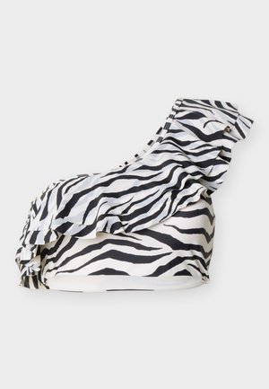 Ein einseitiges Bikinioberteil mit schwarz-weißen Zebramustern und einer Rüschendetail entlang des Ausschnitts auf weißem Hintergrund.