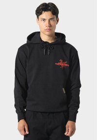 Sudadera negra con un bolsillo frontal, capucha con cordón y diseño gráfico rojo en el pecho, que presenta el texto "PAS DE MAROCO". Textura suave.