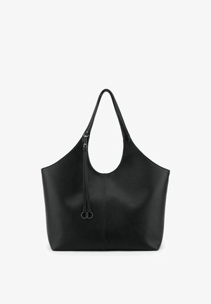 Black leather tote bag with a large open top, single shoulder strap, and decorative tassel with metal rings on front.