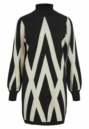Robe pull tricotée noire et crème avec un col haut, ornée d'un motif en zigzag audacieux et de longues manches bouffantes.