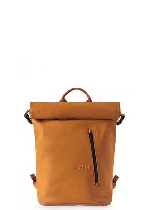 Sac à dos beige à fermeture roulante avec une poche zippée verticale et un logo "a/u" embossé sur le devant, doté d'une poignée supérieure et de bretelles ajustables.