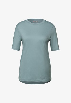 T-shirt bleu clair à manches courtes en coton doux. Il présente un col rond et une coupe décontractée avec un ourlet légèrement arrondi. Design simple.