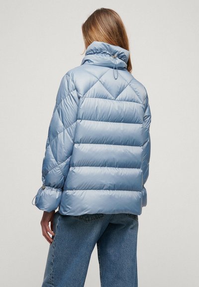 Light blue puffer jacket with diamond quilted design, high collar, drawstring closure at neck, and elastic cuffs. Soft, shiny texture.