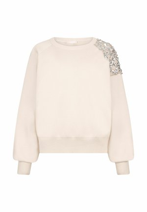 Felpa beige con scollo rotondo, maniche raglan e un dettaglio decorativo impreziosito sulla spalla sinistra come accento.