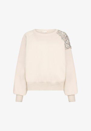 Felpa beige con scollo rotondo, maniche raglan e un dettaglio decorativo impreziosito sulla spalla sinistra come accento.
