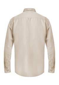 Chemise beige à manches longues en tissu doux. Dotée d'un col classique, de poignets boutonnés et d'un ourlet légèrement courbé. Design minimaliste.