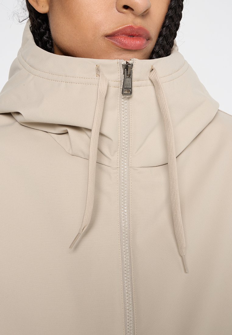 Lichtbeige hoodie met een ritssluiting. Heeft een gestructureerde stof, verstelbare trekkoorden en een kangoeroezak ontwerp.