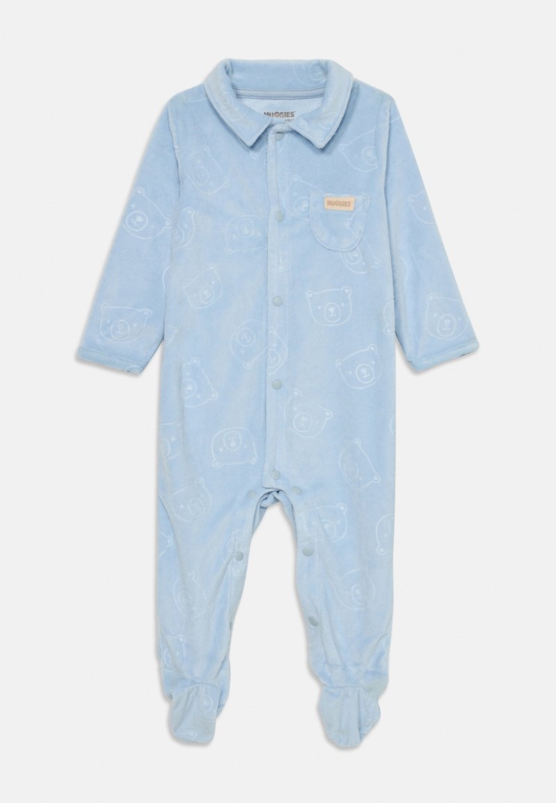 Kék bolyhos kezeslábas hosszú ujjú, gombos záródással és medvearc mintával. Gallérral és bordás lábujjakkal rendelkezik. Kicsi zseb a mellrészen.