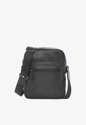 Czarna skórzana torba na ramię z przednią kieszenią na zamek i regulowanym paskiem z tkaniny na białym tle.