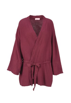 Maroon wrap top made of textured fabric with a tied belt at the waist and wide sleeves, featuring a deep V-neckline and relaxed fit.