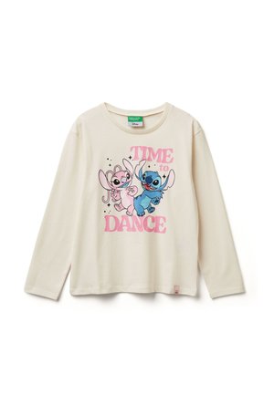T-shirt a maniche lunghe color crema. Presenta una grafica rosa e blu di due personaggi con la scritta "È ora di ballare" in grassetto rosa. Realizzata in morbido cotone.