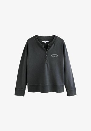 Dark gray sweatshirt with a ribbed neckline, button placket, and embroidered "New York City" detail. Soft texture and cropped design.