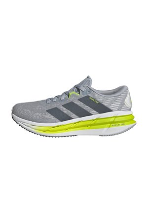 Chaussure de course Adidas gris clair avec des rayures gris foncé, des accents jaune néon sur la semelle intermédiaire et une semelle coussinée étiquetée "Repetitor."