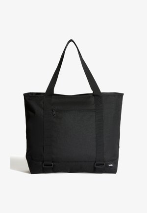 Czarna torba typu tote Vans z dwoma długimi uchwytami, przednią kieszenią na suwak i etykietą z logo w dolnym rogu na białym tle.
