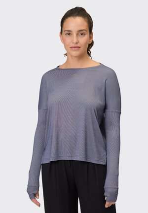 Long-sleeve, loose-fitting top in a light blue mesh fabric. Features thumbholes, rounded neckline, and subtle branding at the chest.