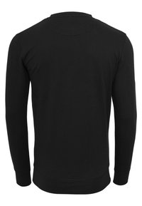 Sweat-shirt noir à manches longues avec un col rond. Fabriqué en mélange de coton doux, présentant un design simple et des poignets côtelés.