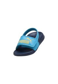 Blauwe en marineblauwe Puma slide sandaal met verstelbare band en logo op de band, ontworpen voor casual gebruik.