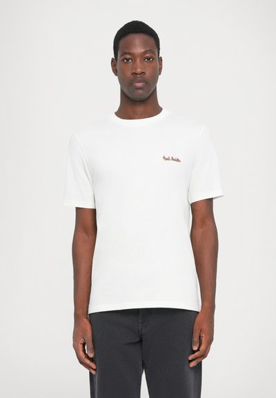 Camiseta blanca de algodón con mangas cortas, cuello redondo y pequeño logo bordado en el lado izquierdo del pecho en rojo y verde.