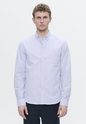 Button-up shirt in blue and white stripes, long sleeves, collar, and a small logo on the chest. Cotton fabric with smooth texture.
