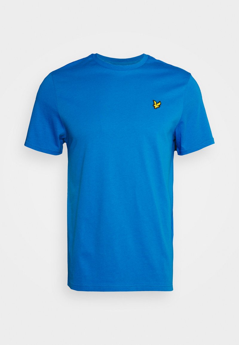Tricou din bumbac albastru, cu guler rotund și mâneci scurte. Prezintă un mic logo brodat galben pe piept. Textură moale, design casual.
