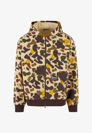 Felpa con cappuccio e zip di colore beige con un motivo camouflage che presenta faccine sorridenti marroni, verdi e gialle. Include tasche frontali e polsini a coste.