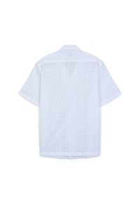 Camicetta bianca a maniche corte con colletto alla francese, caratterizzata da un motivo perforato e uno yoke posteriore. Il tessuto ha una consistenza leggera e traspirante.